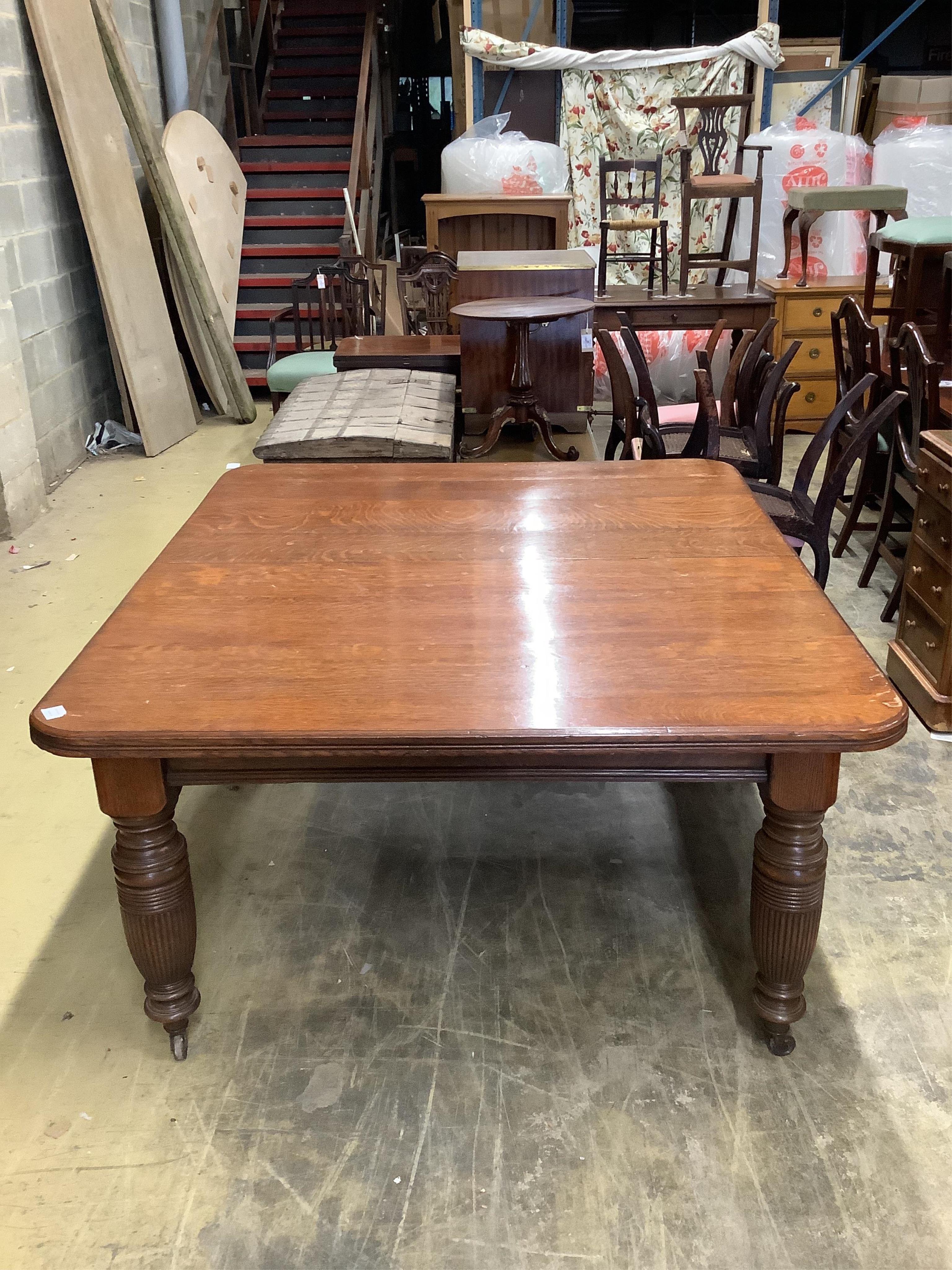 A late Victorian oak extending dining table, with three spare leaves, width 290cm extended, depth 135cm, height 74cm. Condition - fair
